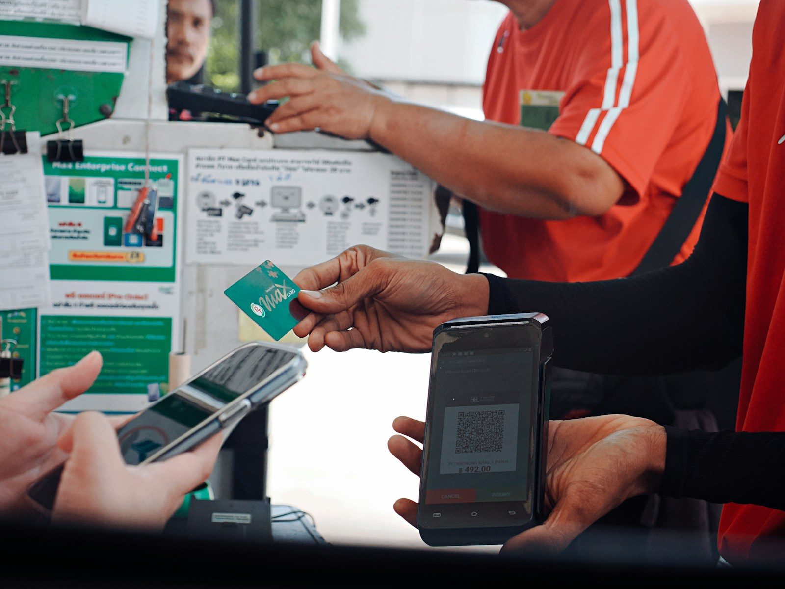 Customer paying with smartphone and credit card at checkout
