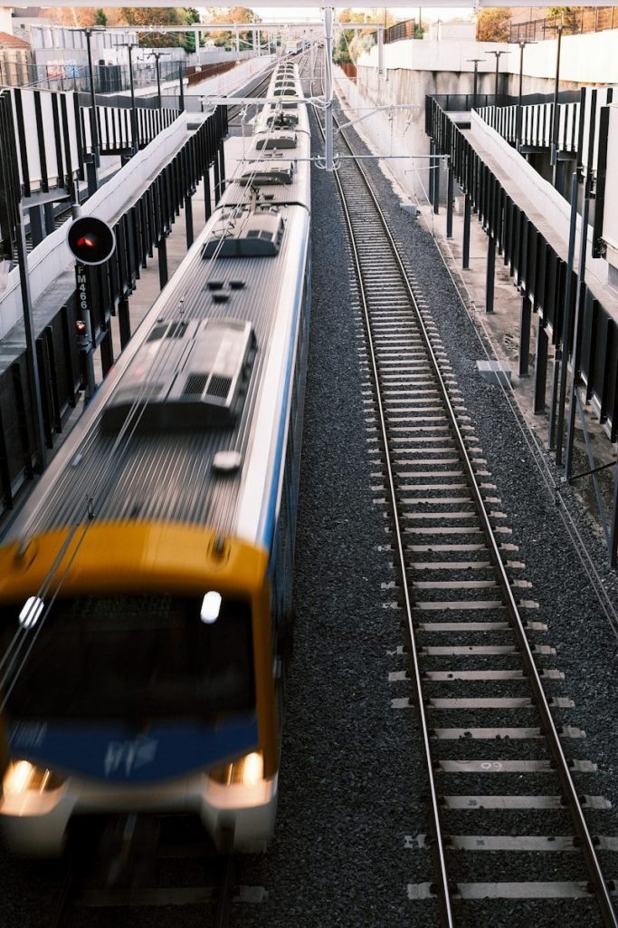 a yellow and blue train traveling down train tracks